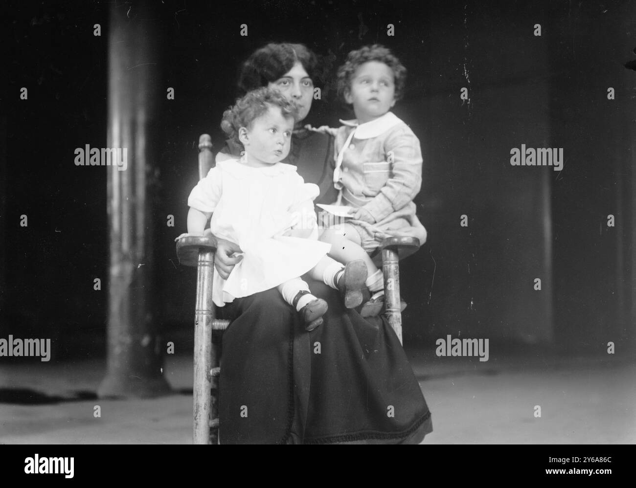 Mme. Navratil and sons, Photograph shows French brothers Michel (age 4) and Edmond Navratil (age 2) of Nice, France, seated on their mother's lap. To board the ship, their father assumed the name Louis Hoffman and used their nicknames, Lolo and Mamon. Their father died in the disaster of the RMS TITANIC, which struck an iceberg in April 1912 and sank, killing more than 1,500 people., 1912 May 16, Children, Glass negatives, 1 negative: glass; 5 x 7 in. or smaller. Stock Photo