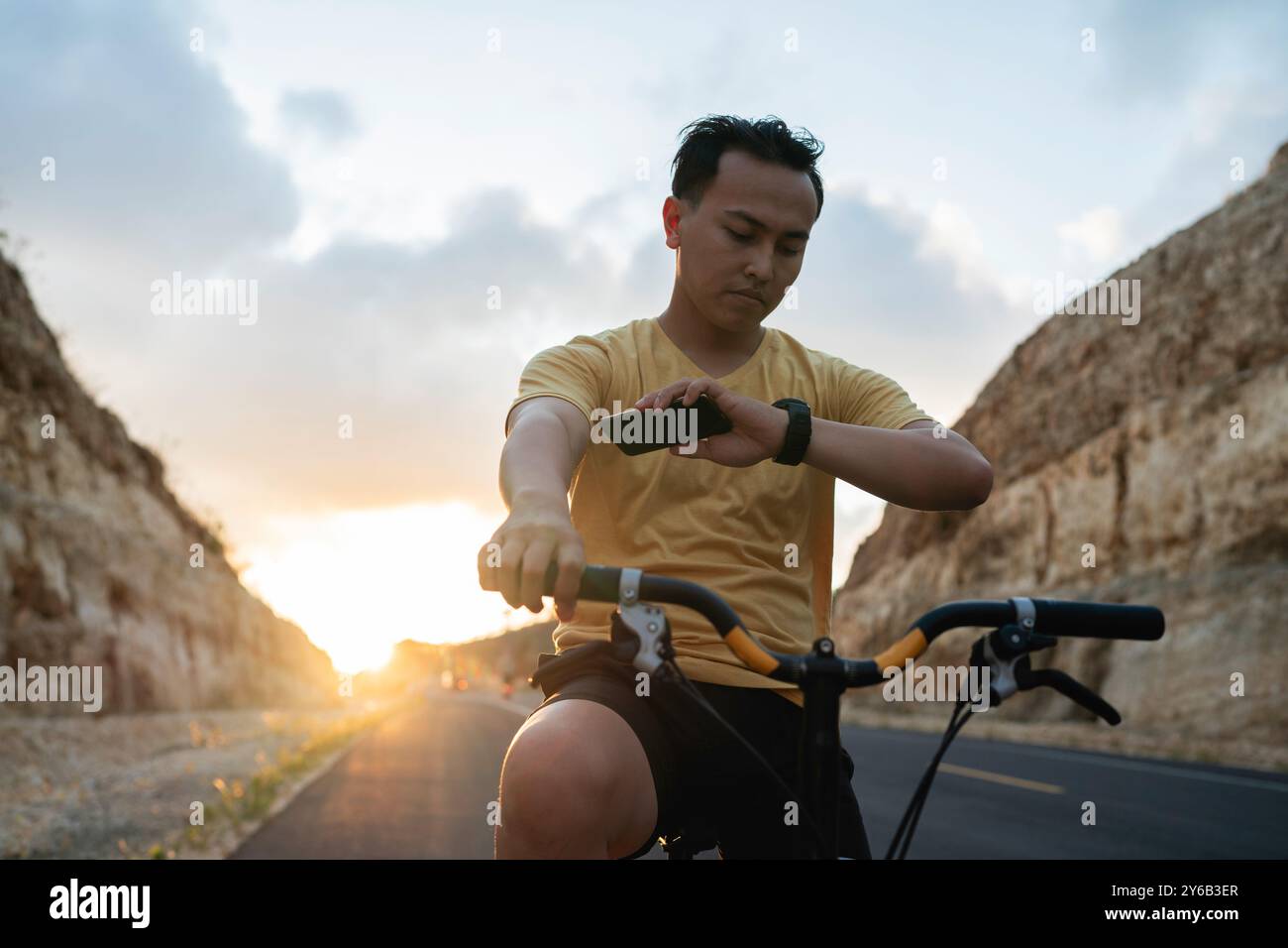 male biker wearing digital watch checking time Stock Photo - Alamy