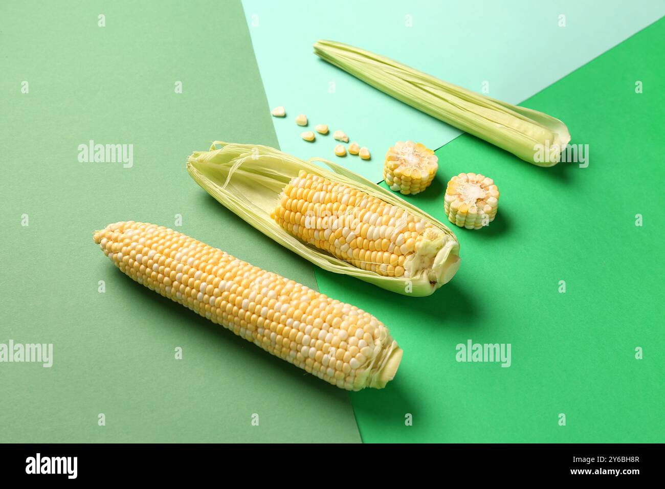 Fresh corn cobs and seeds on colorful background Stock Photo