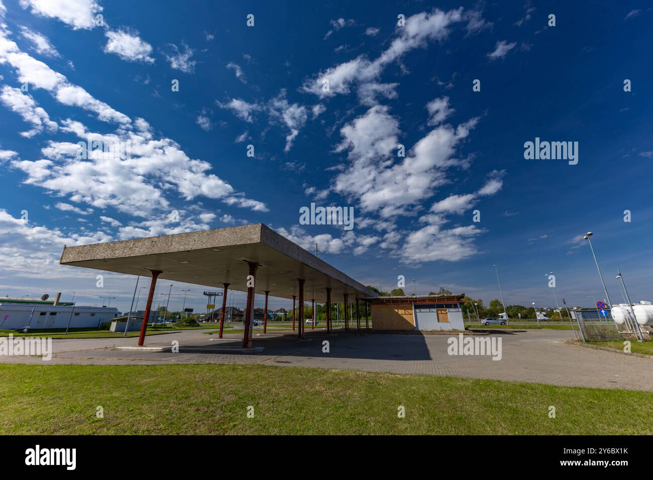 Inactive and abandoned gas station, inactive dispensers, boarded up ...