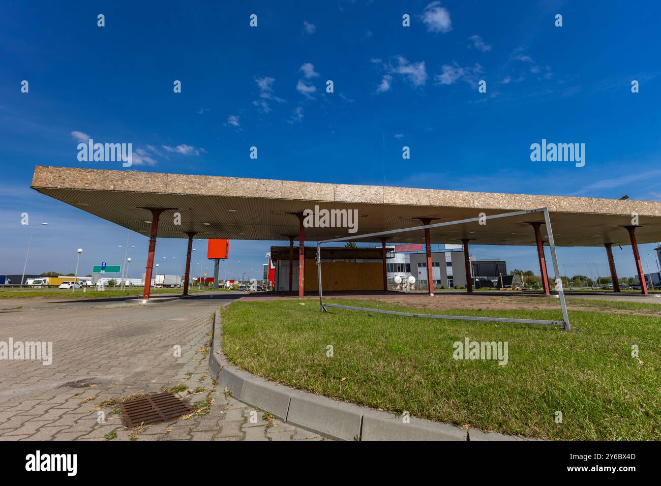 Inactive and abandoned gas station, inactive dispensers, boarded up ...