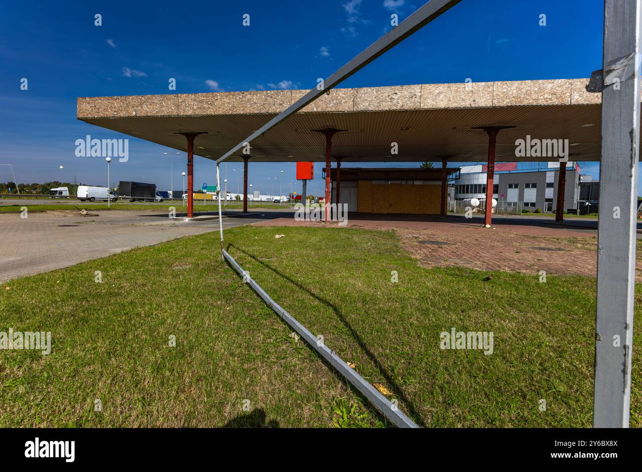 Inactive and abandoned gas station, inactive dispensers, boarded up ...