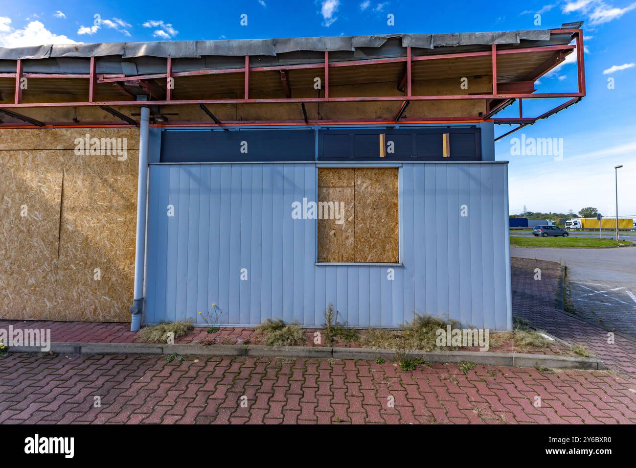 Inactive and abandoned gas station, inactive dispensers, boarded up ...