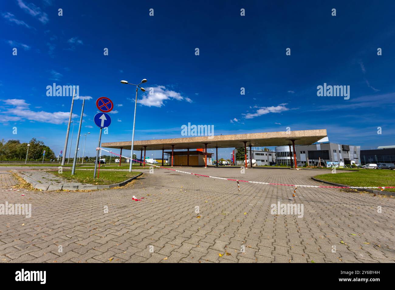 Inactive and abandoned gas station, inactive dispensers, boarded up ...