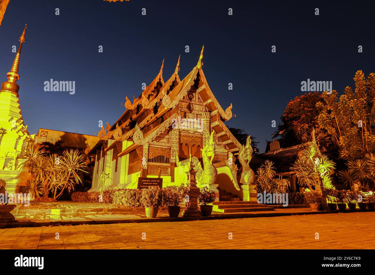 A beautifully lit traditional Thai temple at night in Chiang Mai with ...