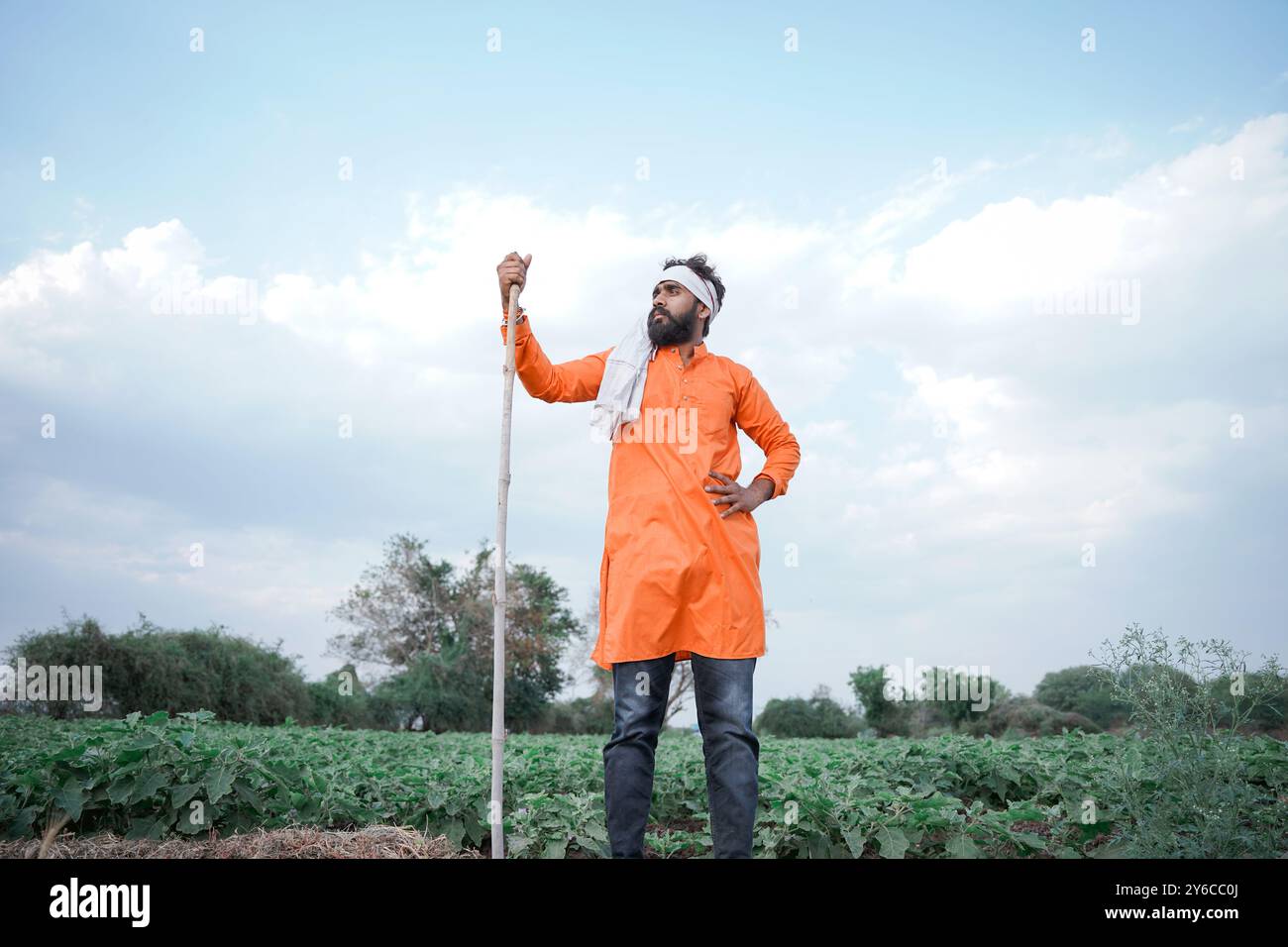 Indian farmer, young, standing on an agricultural field Stock Photo - Alamy