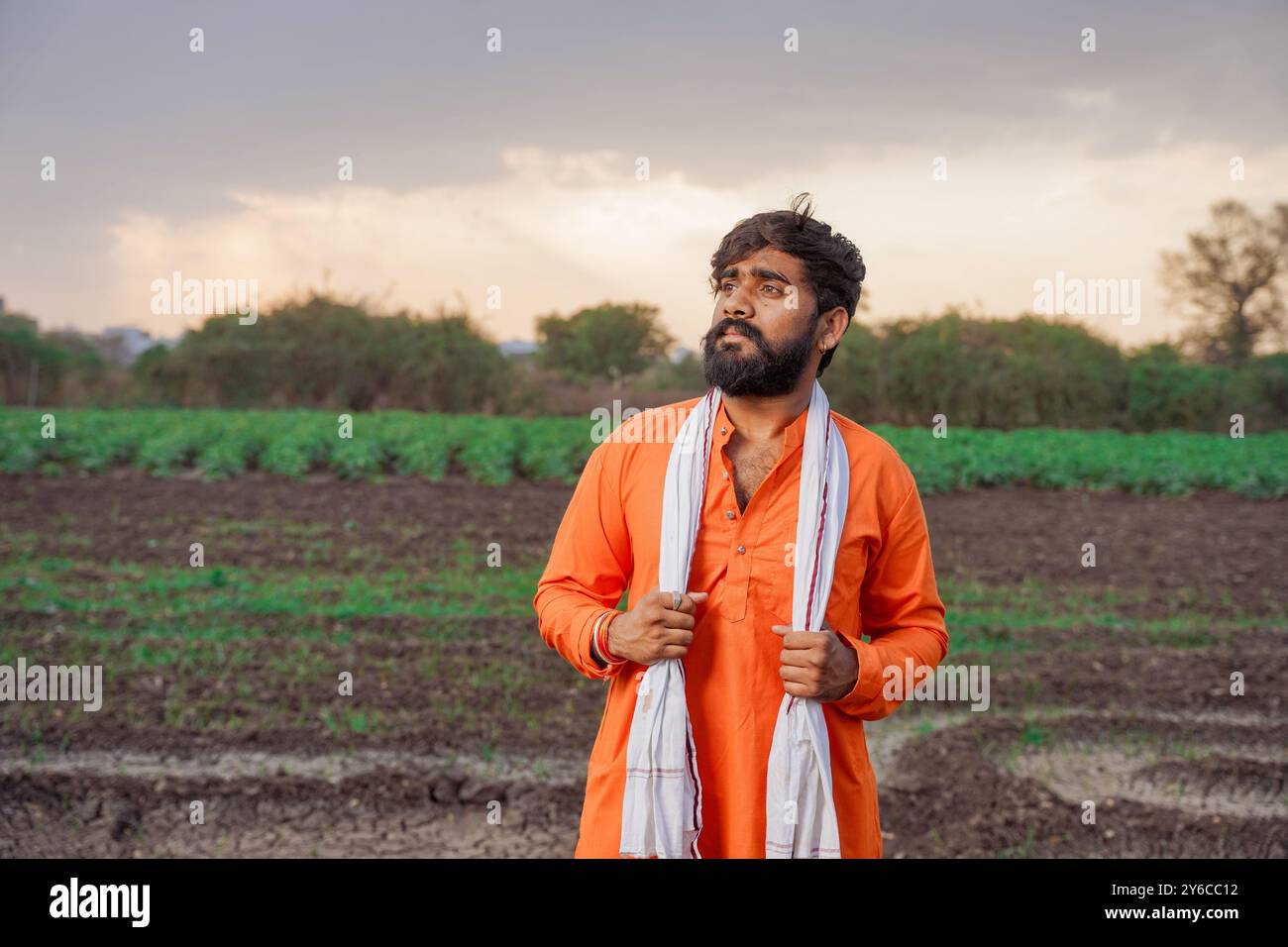 Indian farmer, young, standing on an agricultural field Stock Photo - Alamy