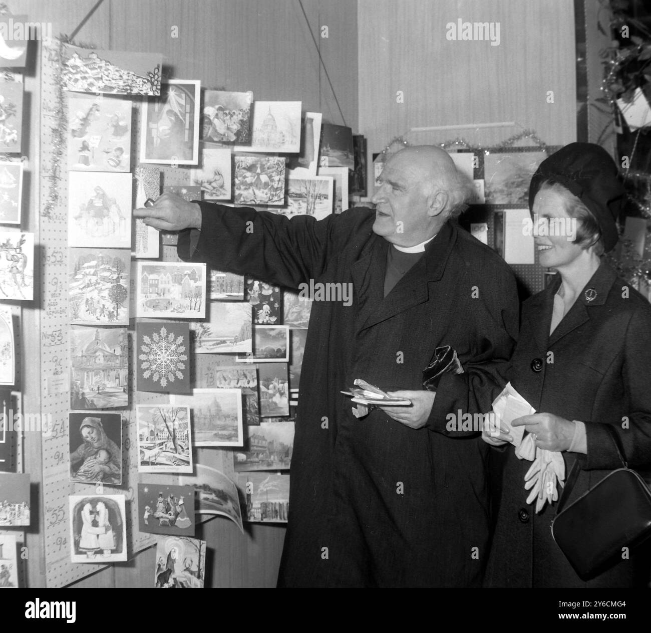 ARCHBISHOP OF CANTERBURY MICHAEL RAMSEY WITH WIFE BUYING CHRISTMAS CARDS IN LONDON /  ;  18 NOVEMBER 1963 Stock Photo