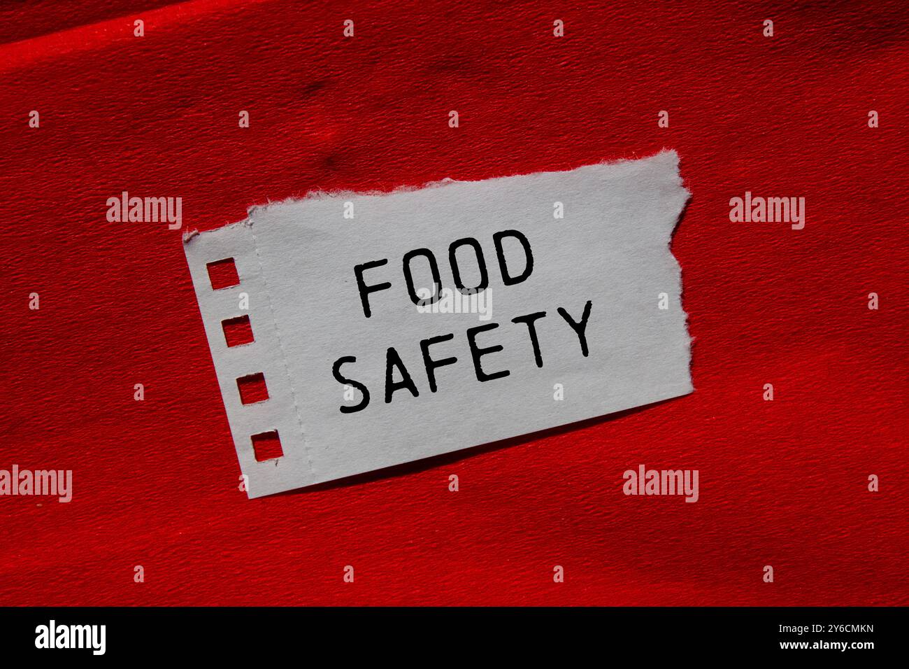 Food safety message written on ripped torn paper piece on red ...
