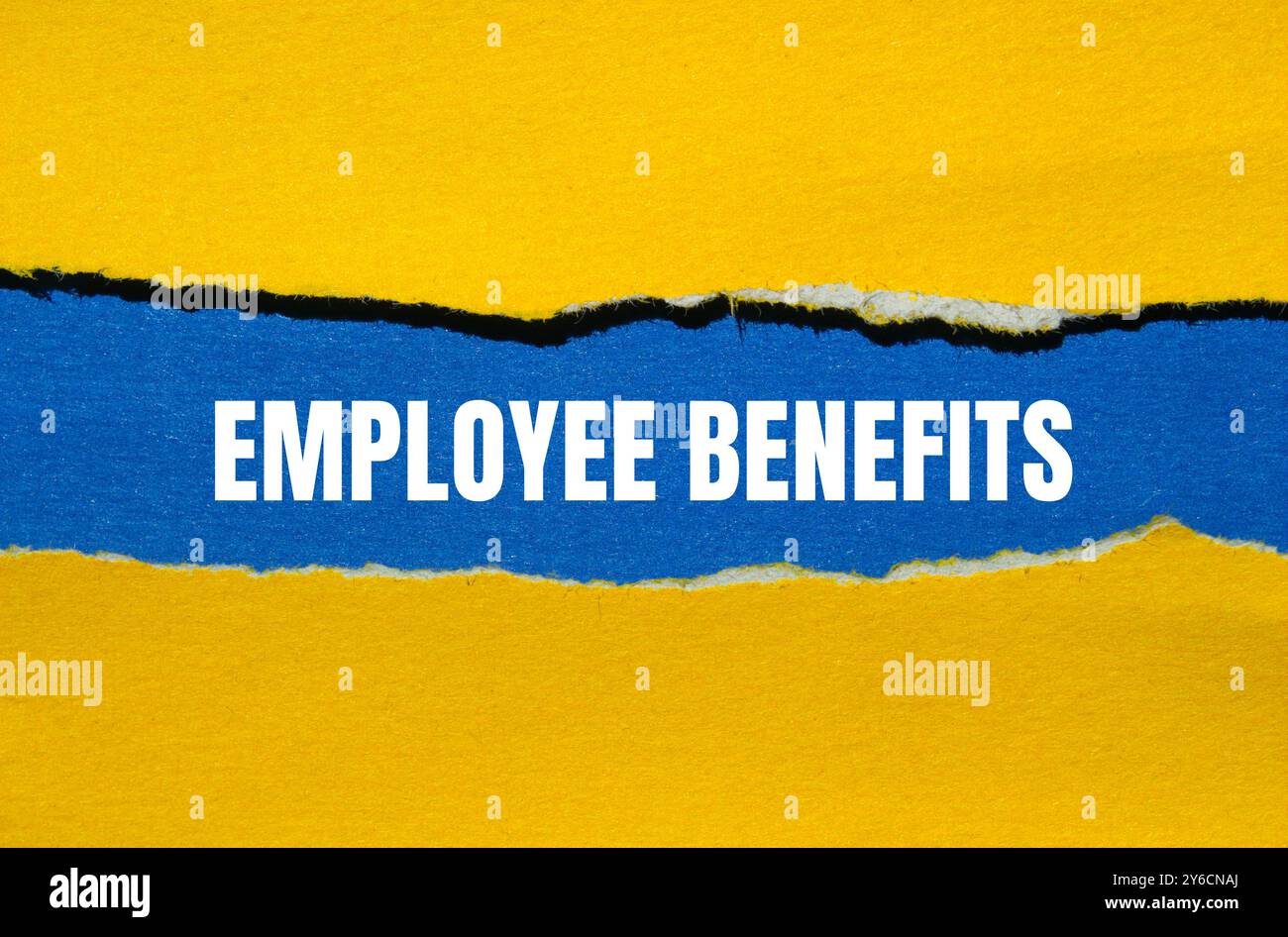 Employee benefits message written on ripped torn yellow paper with blue ...