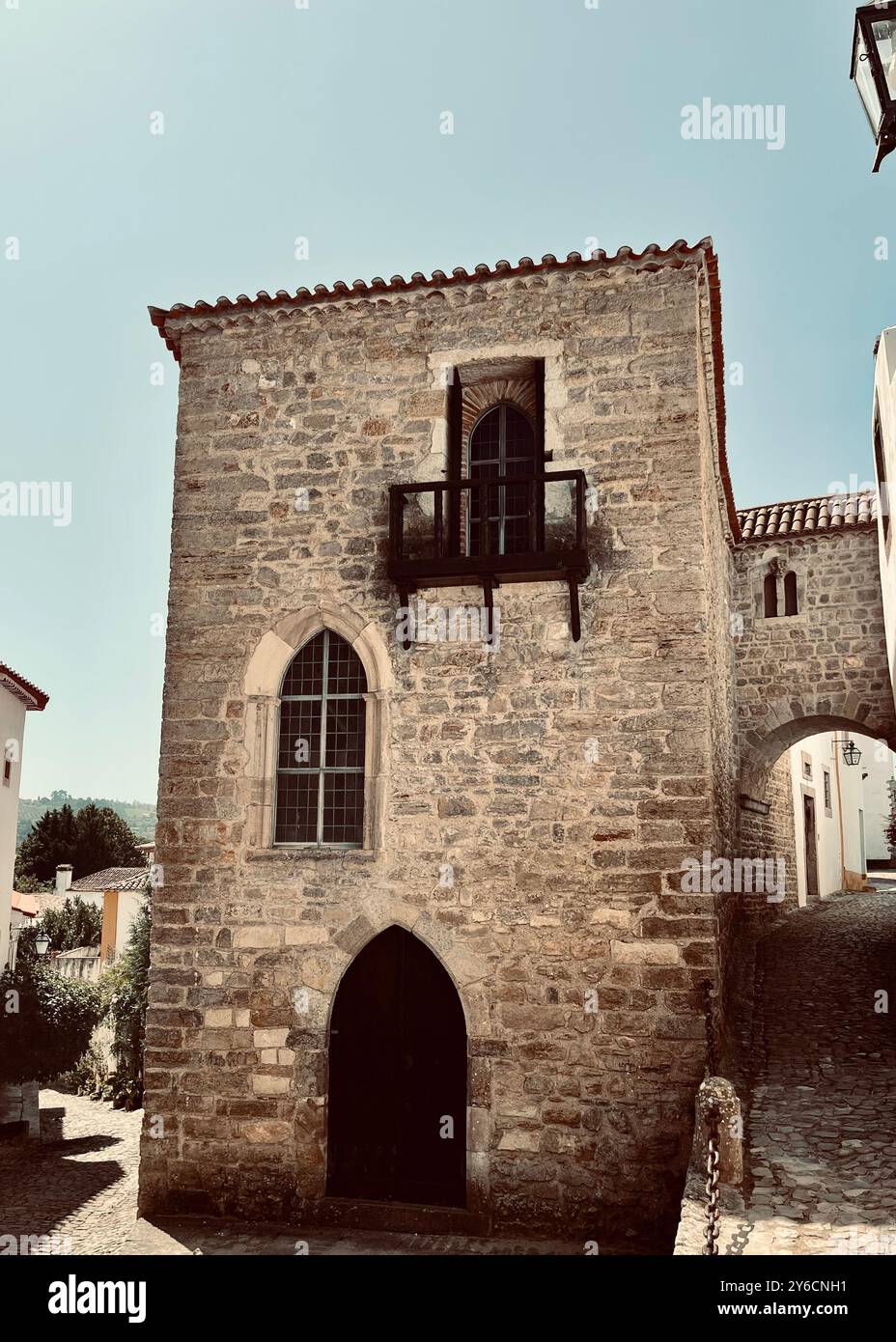 A historic stone building with arched windows and a small balcony under ...