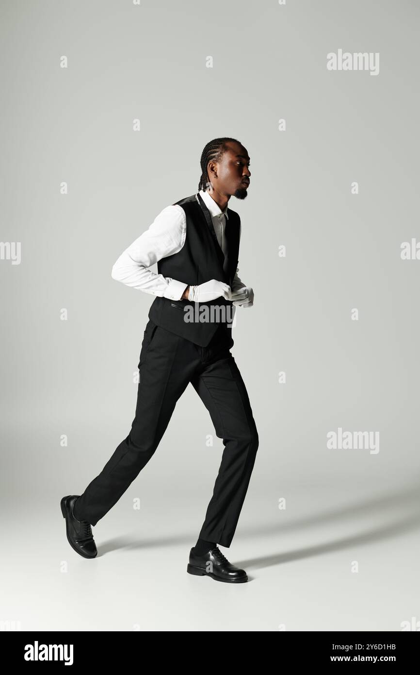 A young African American man confidently strides in a tailored suit ...