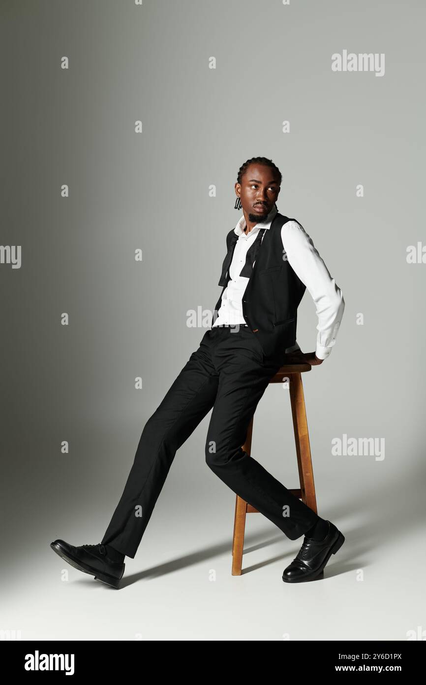 A young African American man in a tailored suit exudes confidence while ...