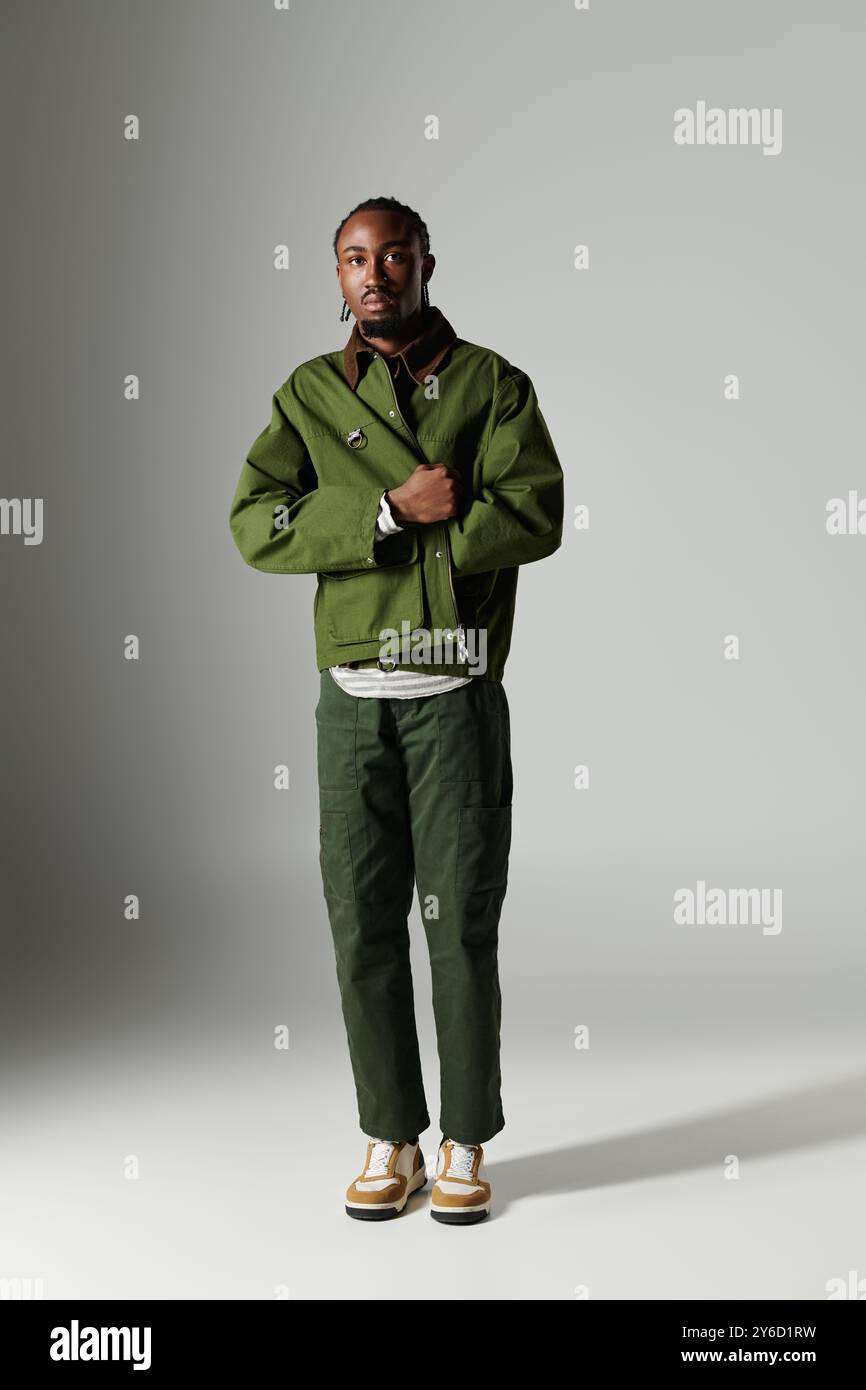 A young African American man showcases his fashion sense in a stylish ...