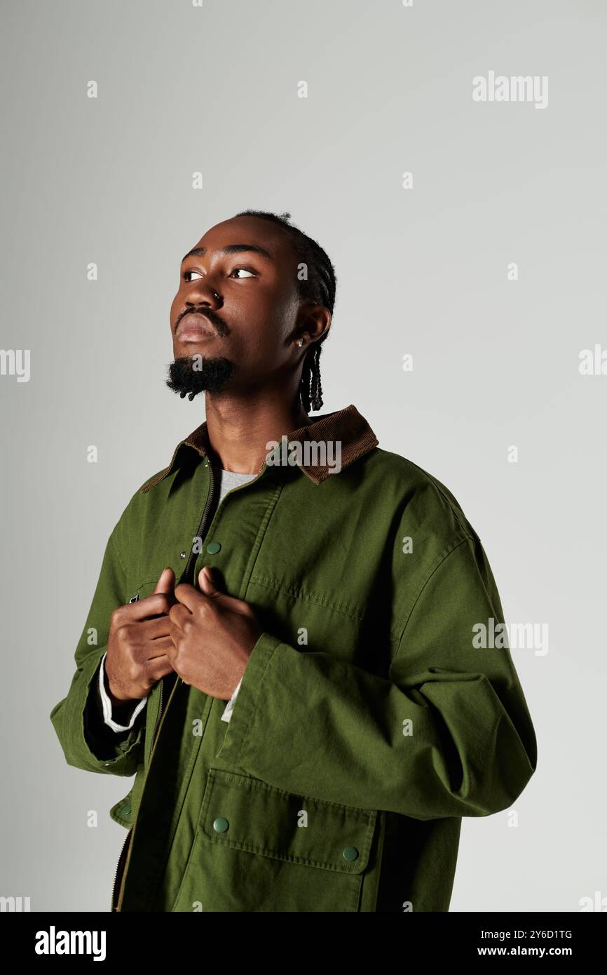 A young African American man showcases his fashion in a striking green ...