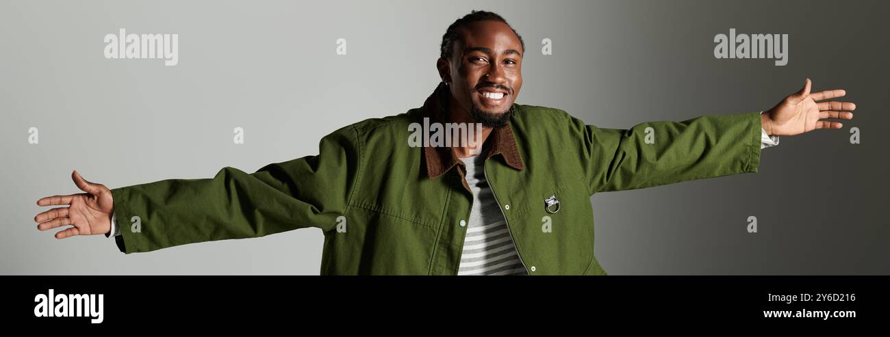 A young African American man showcases his fashionable green outfit ...