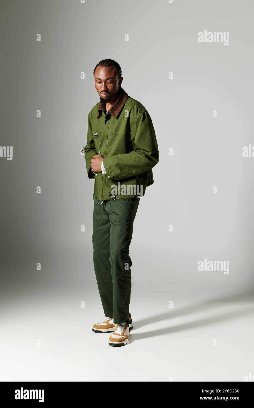 A stylish young man dressed in green attire strikes a confident pose on ...