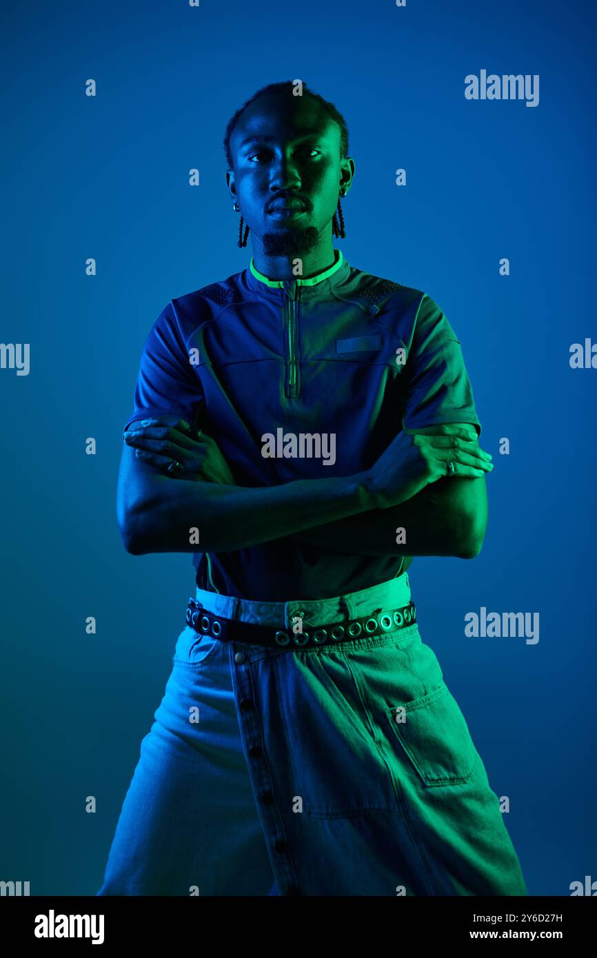 A young African American man showcases his style while posing ...