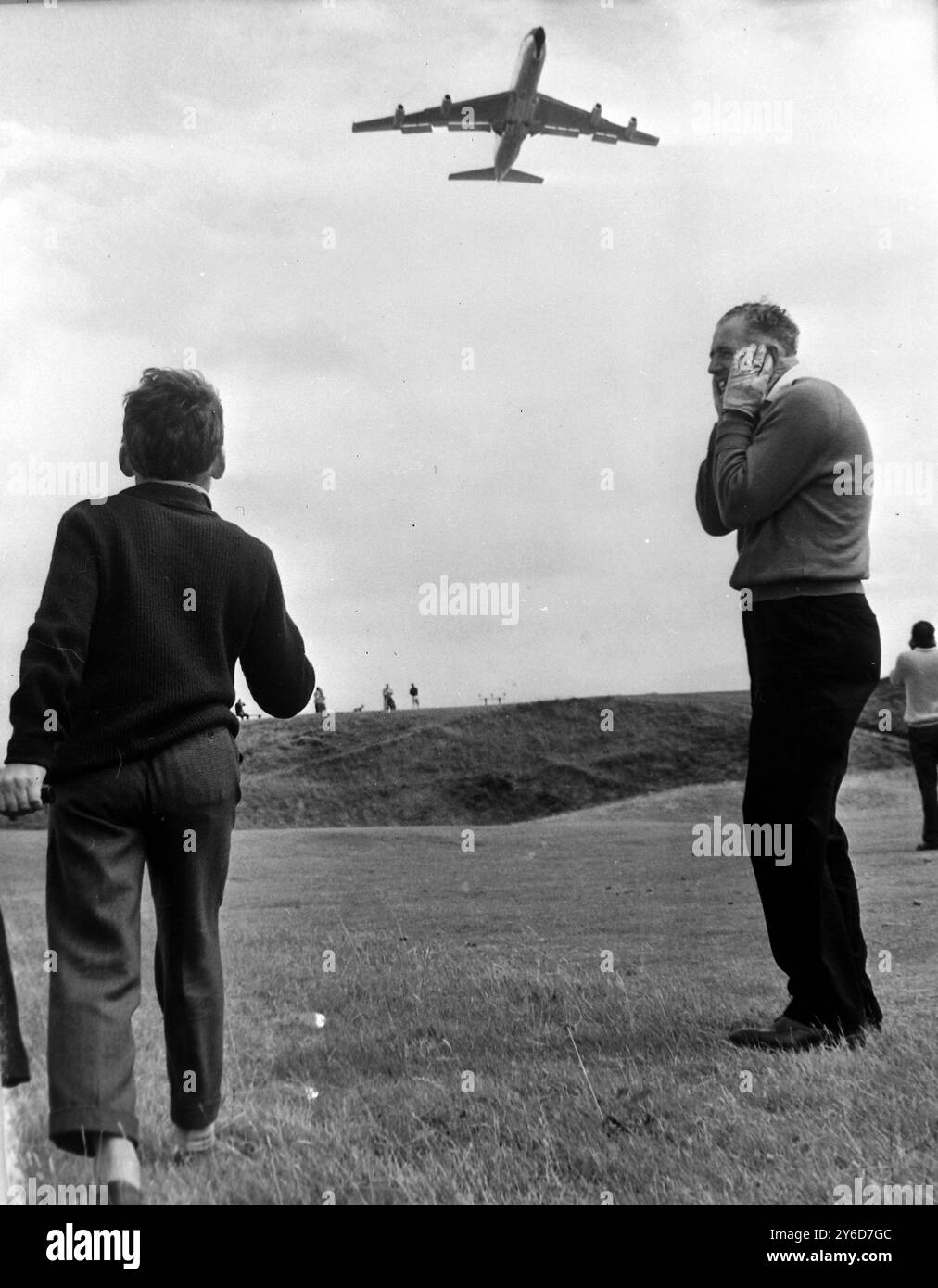 GOLFER J WALKER DISTRACTED BY NOISY PLANE BOEING IN TROON   ;  16 JULY 1963 Stock Photo