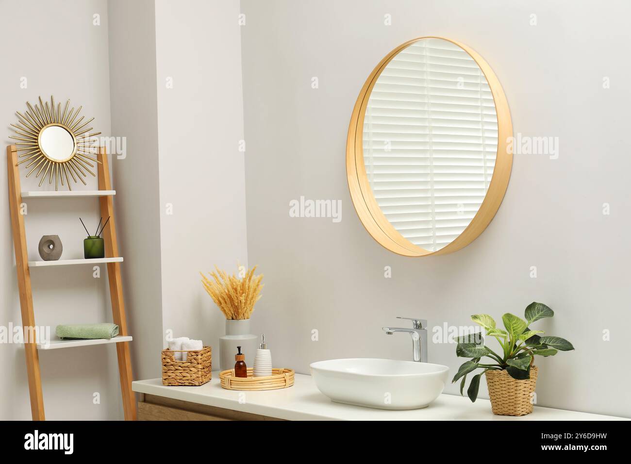 Round mirror over sink in bathroom. Interior design Stock Photo - Alamy