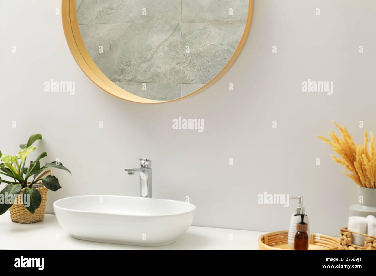 Round mirror over sink in bathroom. Interior design Stock Photo - Alamy