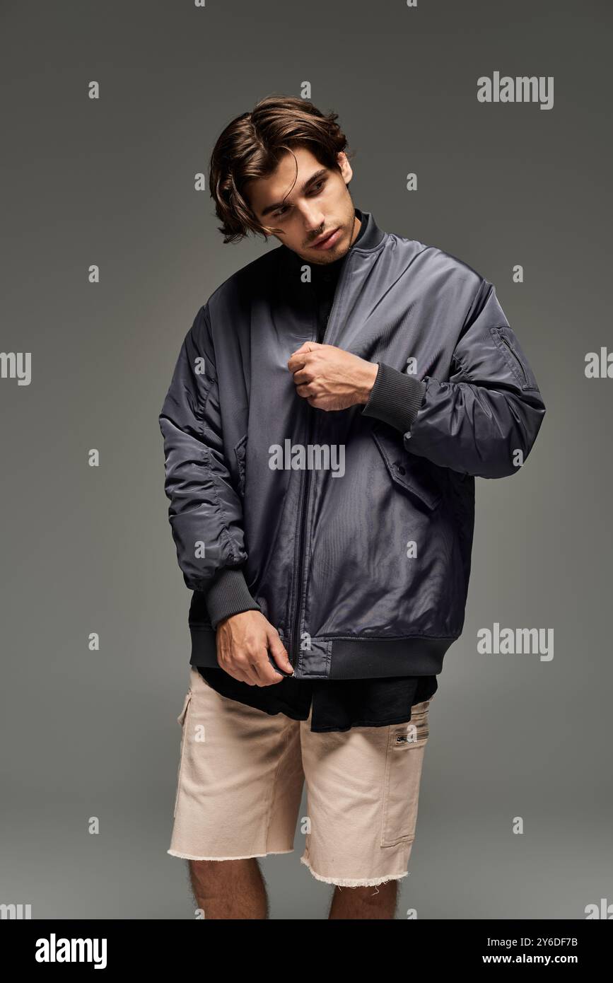A fashionable young man poses confidently in a chic autumn outfit ...