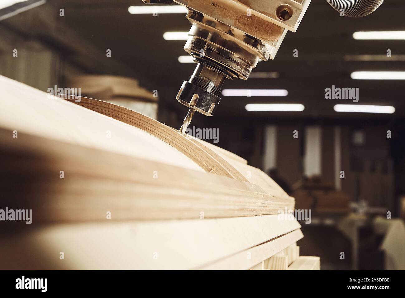 four-axis numerically controlled woodworking machine cuts out complex lines on the canvas. CNC, computer control. Stock Photo