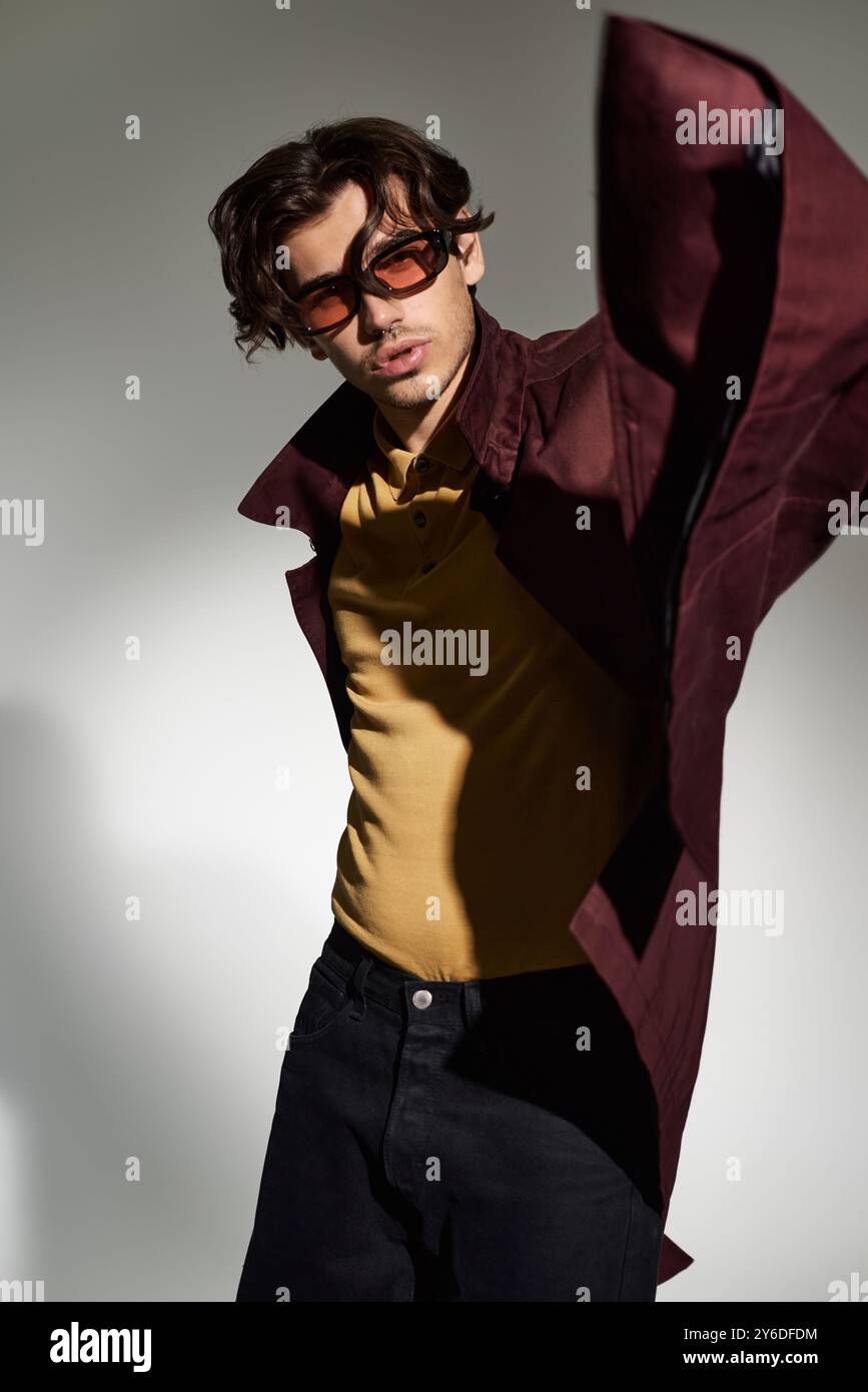 A young man poses confidently in a chic autumn outfit, blending style ...