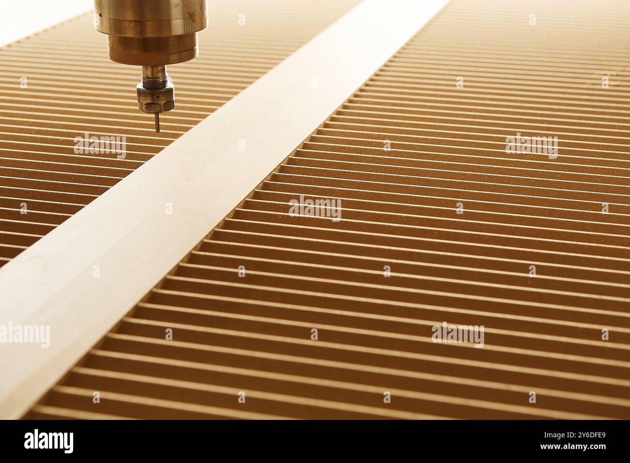 Numerically controlled woodworking machine cuts complex lines on the canvas. Computer numerical control. CNC. Stock Photo