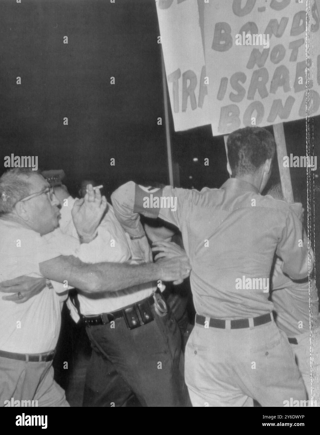 Miami Beach , Florida : An angry bystander lunges at a uniformed member ...