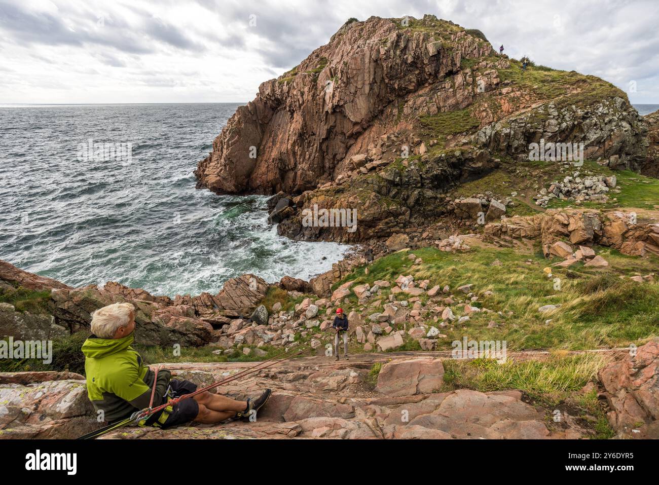 You can practise abseiling on the rugged rocks of the Kullaberg peninsula under the guidance of a guide. Italienska vägen, Höganäs kommun, Skåne, Sweden Stock Photo