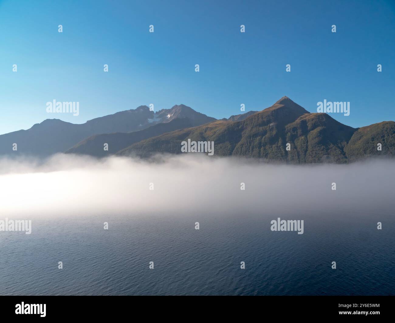 Layer of mist and mountains in Hjorundfjord, Norway Stock Photo - Alamy