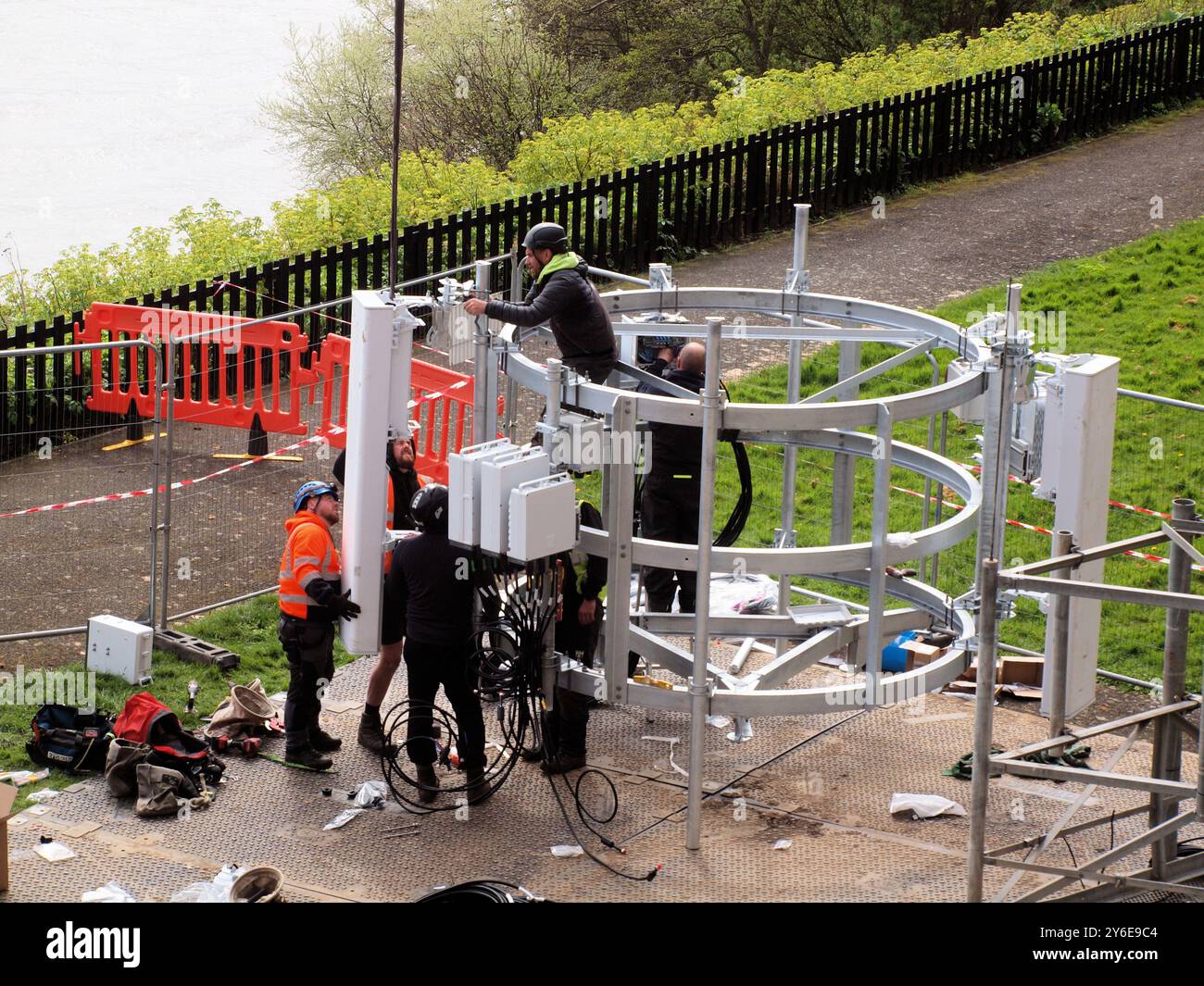 Communication workmen replacing Three Gee  phone network with new Five Gee upgrades at a coastal tenement complex in North Tyneside. Stock Photo