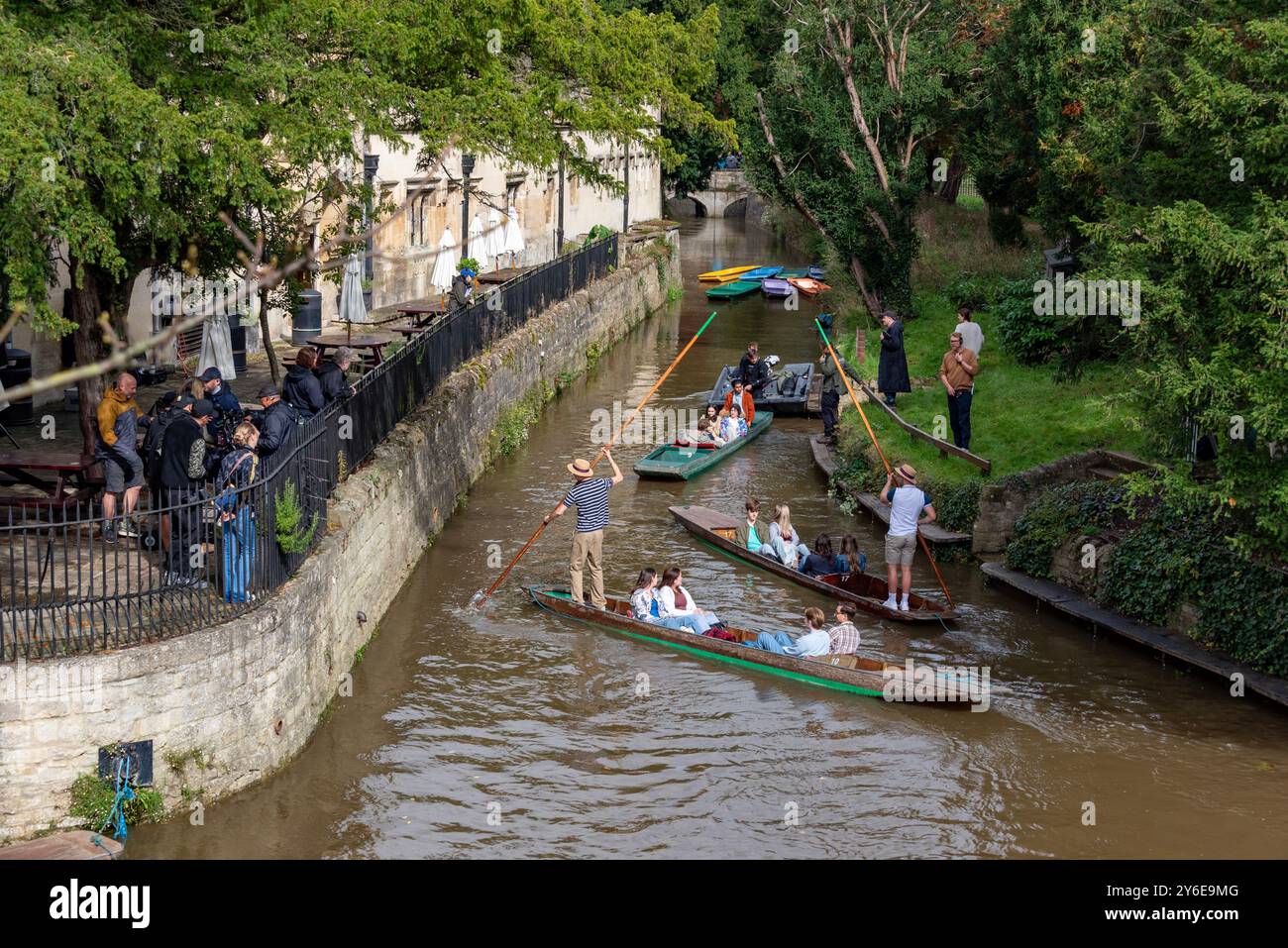 Oxford, UK, 25th September 2024.  A Netflix film crew and cast preparing for a take for the forthcoming film 'My Oxford Year', outside Magdalen College. The film is due for release in 2025. This is a punting sequence near Magdalen Bridge boathouse on the River Cherwell, Oxford. The film stars Sofia Carson, Corey Mylchreest, Dougray Scott and Nikhil Parmar. Credit: Martin Anderson/Alamy Live News Stock Photo