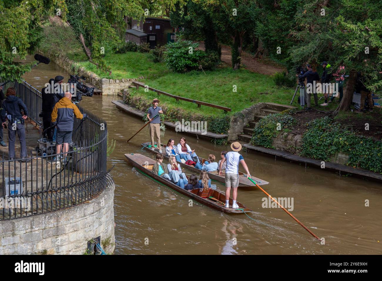 Oxford, UK, 25th September 2024.  A Netflix film crew filming a take for the forthcoming film 'My Oxford Year', outside Magdalen College. The film is due for release in 2025. This is a punting sequence near Magdalen Bridge boathouse on the River Cherwell, Oxford. The film stars Sofia Carson, Corey Mylchreest, Dougray Scott and Nikhil Parmar. Credit: Martin Anderson/Alamy Live News Stock Photo
