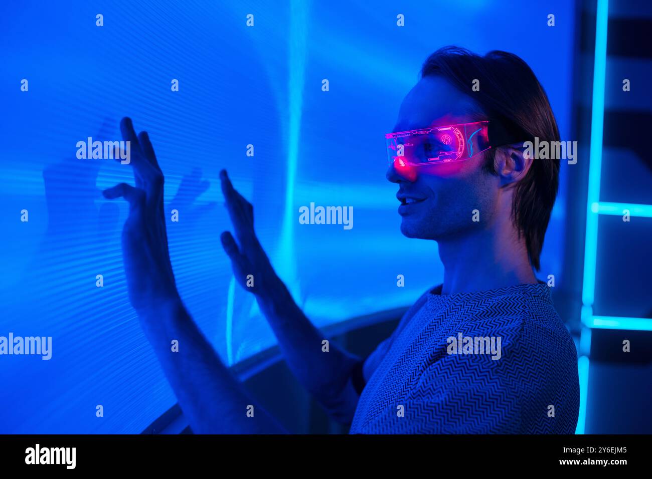 Futuristic portrait of a handsome man with smart neon glasses touch a ...