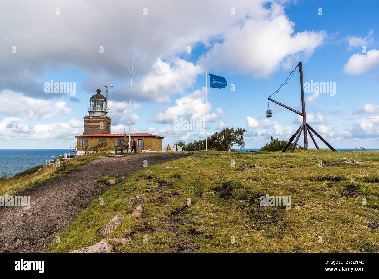 Kullen Lighthouse is the highest lighthouse in Sweden. There have been beacons at this location since 1561, as illustrated by the replica of a fire basket on a wooden frame. At the tip of the Kullaberg peninsula stands the Kullens fyr lighthouse. Italienska vägen, Höganäs kommun, Skåne, Skåne, Sweden Stock Photo