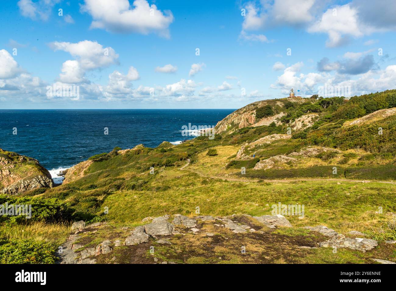 Coastal hike with a view of the Kattegat from Mölle harbor to Kullen lighthouse in the Naturum Kullaberg nature reserve. View of the Kattegat from the Kullaberg nature reserve. At the tip of the Kullaberg peninsula stands the Kullens fyr lighthouse. Italienska vägen, Höganäs kommun, Skåne, Skåne, Sweden Stock Photo