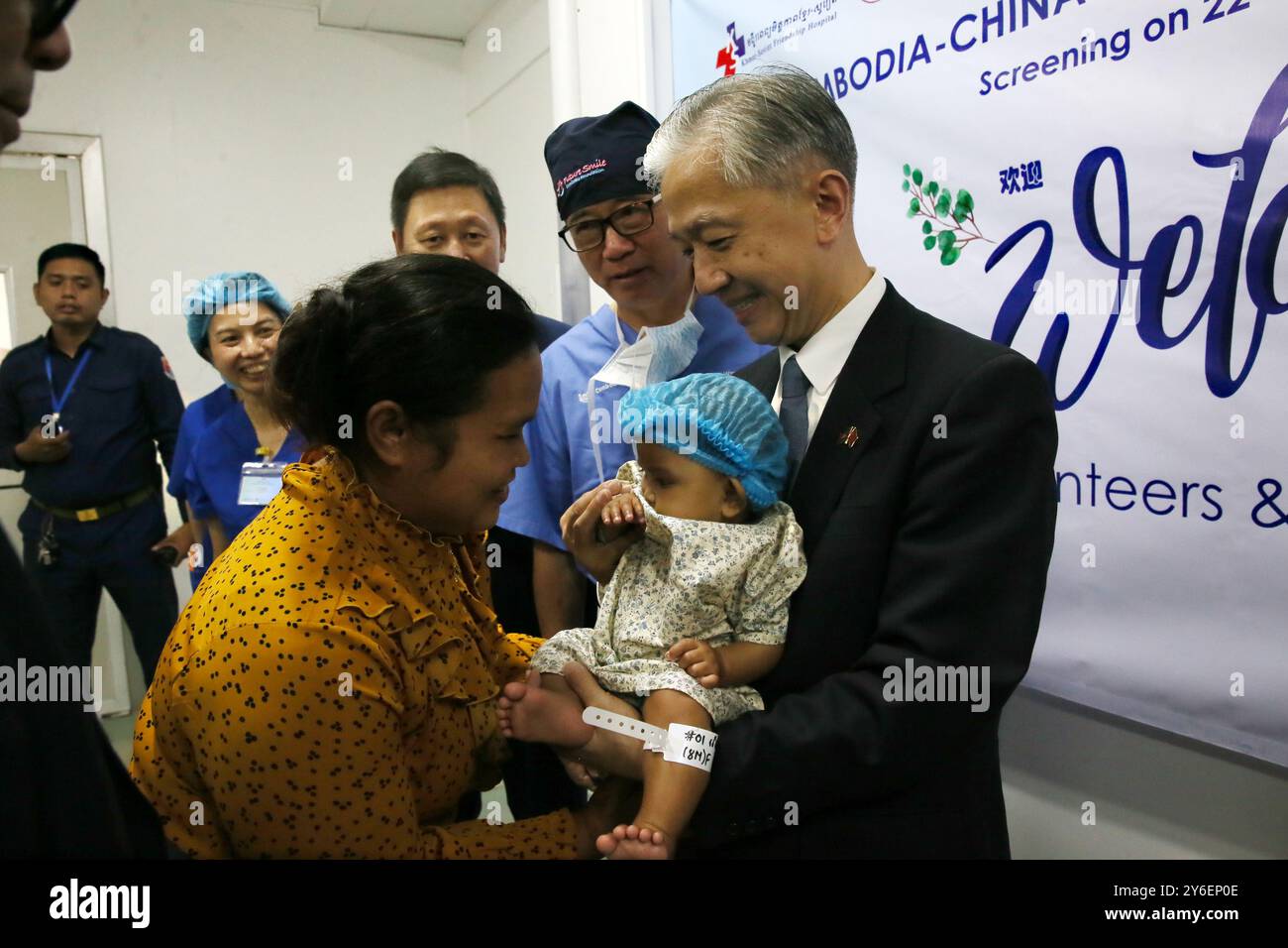 (240925) -- PHNOM PENH, Sept. 25, 2024 (Xinhua) -- Chinese Ambassador to Cambodia Wang Wenbin (1st R) holds a child with facial deformity in Phnom Penh, Cambodia on Sept. 25, 2024. Chinese charitable organization Future Smile Charitable Foundation on Wednesday donated four ambulances to Cambodia and provided free surgical operations to Cambodian children with cleft lip, cleft palate and other facial deformities. (Photo by Phearum/Xinhua) Stock Photo