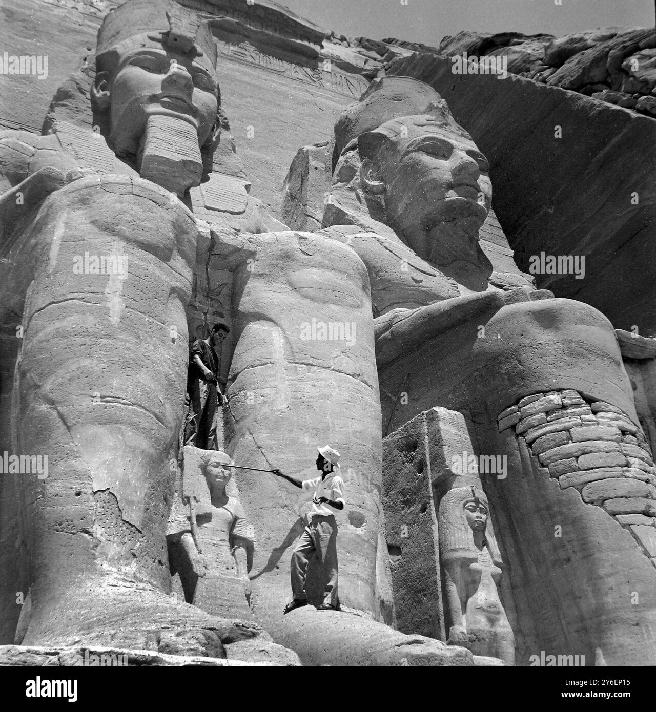 10 OCTOBER 1962  TWO GIANT FIGURES WHO FORM PART OF AN ANCIENT EGYPTIAN TEMPLE WHICH IS TO BE DISMANTLED AND RELOCATED PIECE BY PIECE TO MAKE WAY FOR THE ASWAN DAM. UNITED ARAB REPUBLIC (EGYPT). Stock Photo
