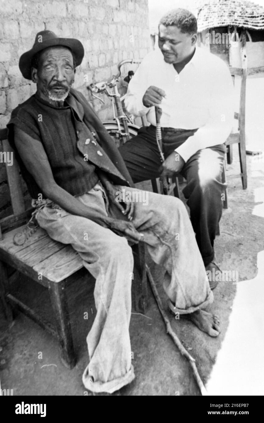 JOSHUA NKOMO NEAR MUD HUT WITH UNCLE IN SOUTHERN RHODESIA /  ;  7 OCTOBER 1962 Stock Photo