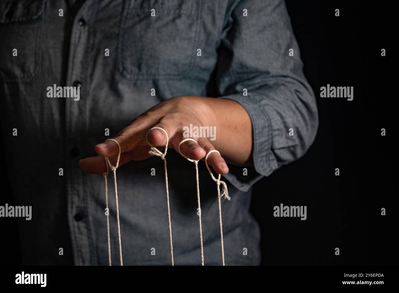 Thread Controlled Puppet Close-up Of Man Controls The Puppet With Fingers. Man`s Hand Controls ...