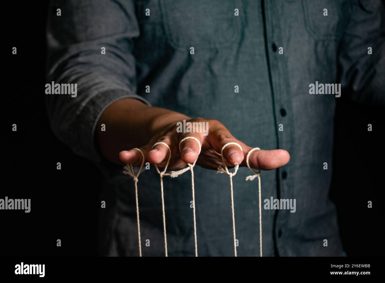 Thread Controlled Puppet Close-up Of Man Controls The Puppet With Fingers. Man`s Hand Controls ...
