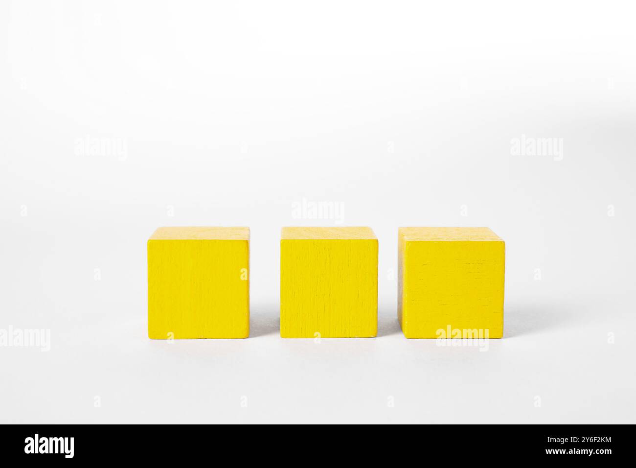 Many yellow wooden cubes isolated on white Stock Photo - Alamy
