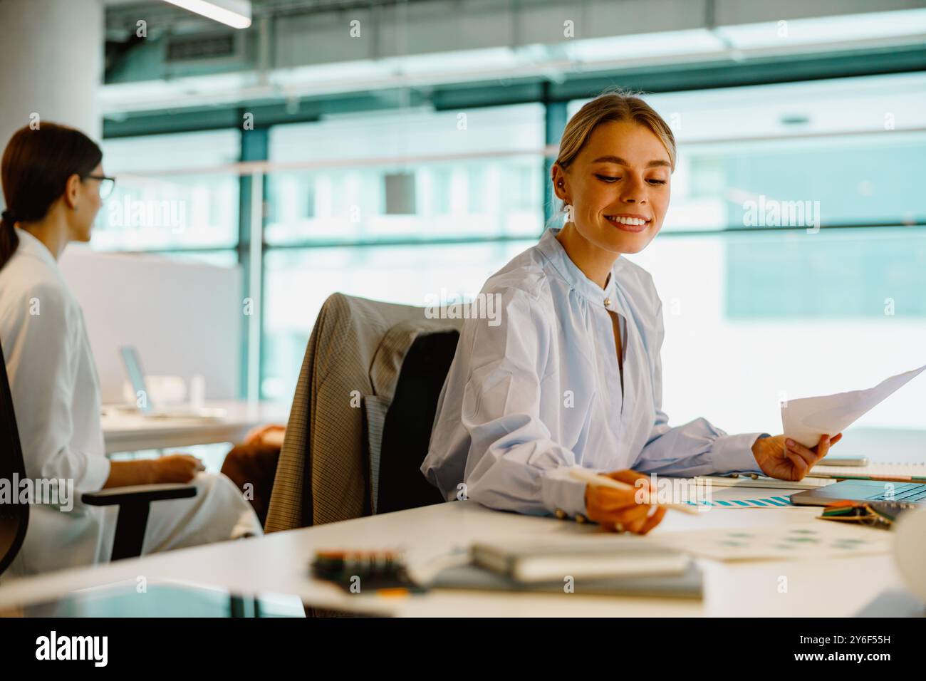 Young Professionals Excitedly Collaborating in a Modern Office Working Environment Stock Photo