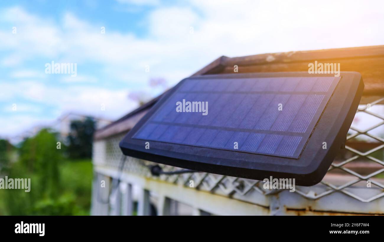 Close up small solar panel designed to power decorative lights along a ...