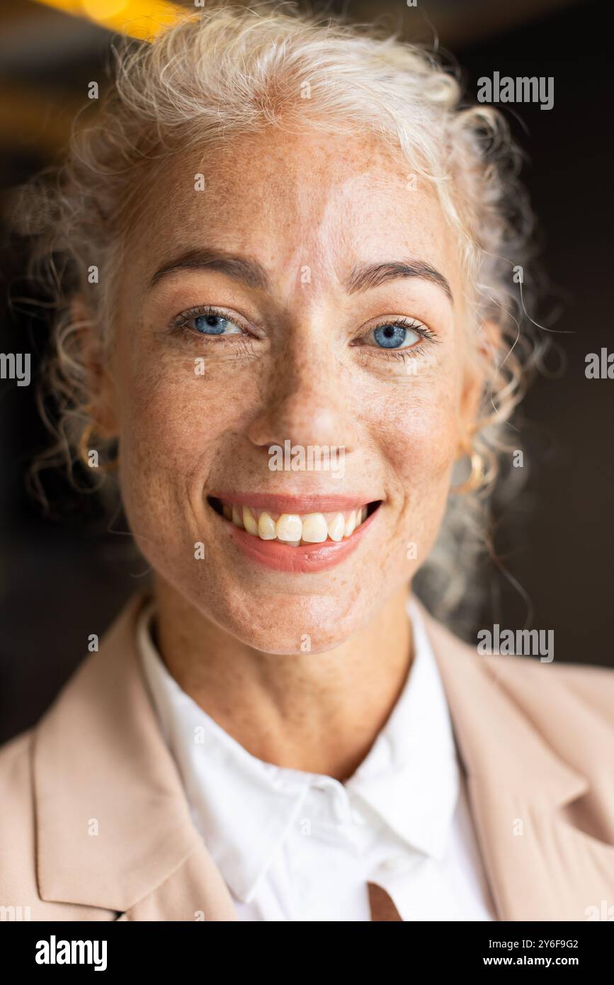 Smiling woman in business attire posing confidently for professional headshot Stock Photo