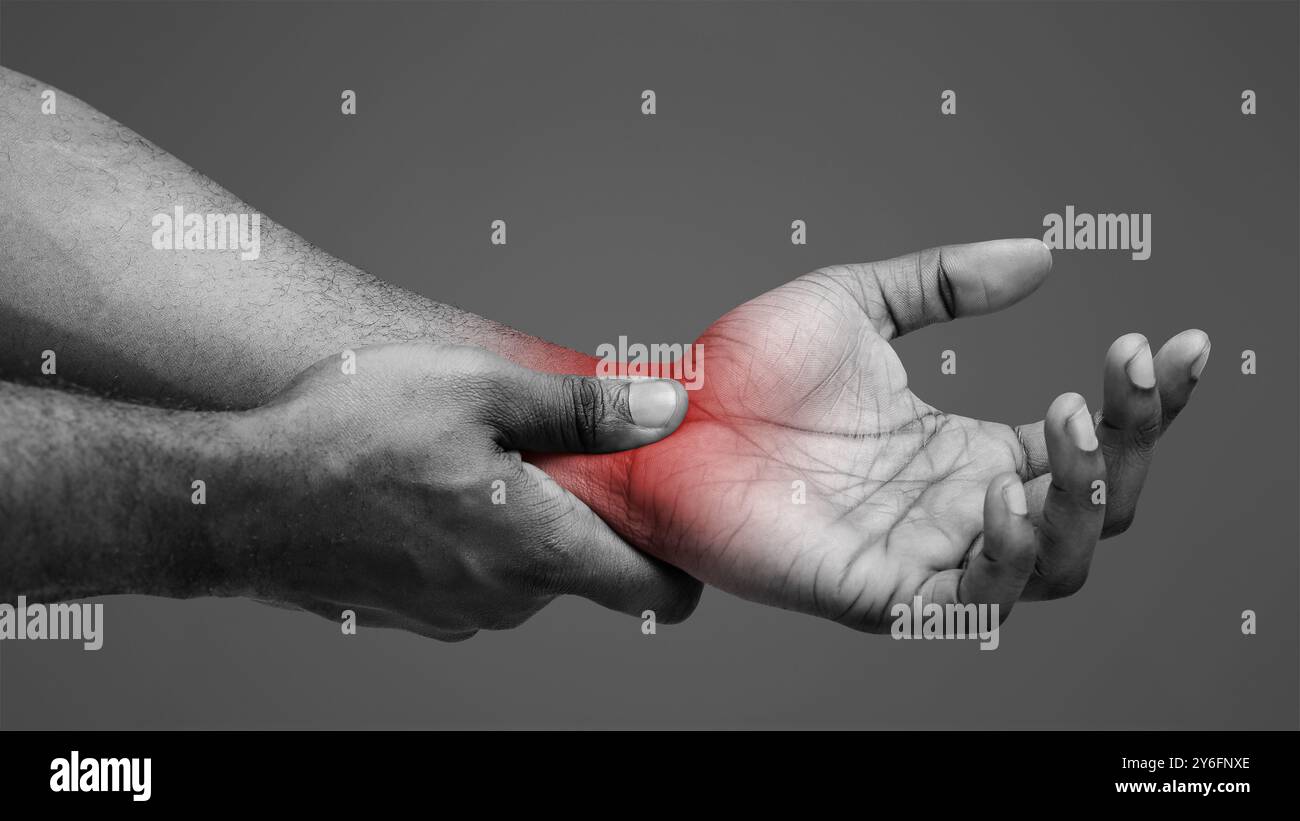 Close up of black guy rubbing his wrist Stock Photo - Alamy