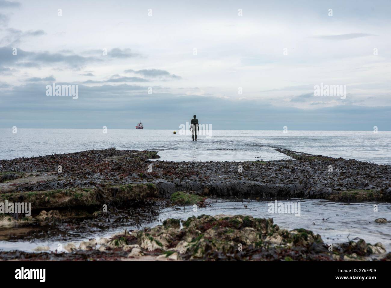 A life-sized sculpture viewed at the coastline of the sea. This statue ...