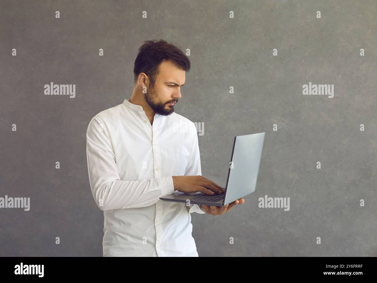 Thoughtful focused smart male programmer or employee working on deadline project. Stock Photo